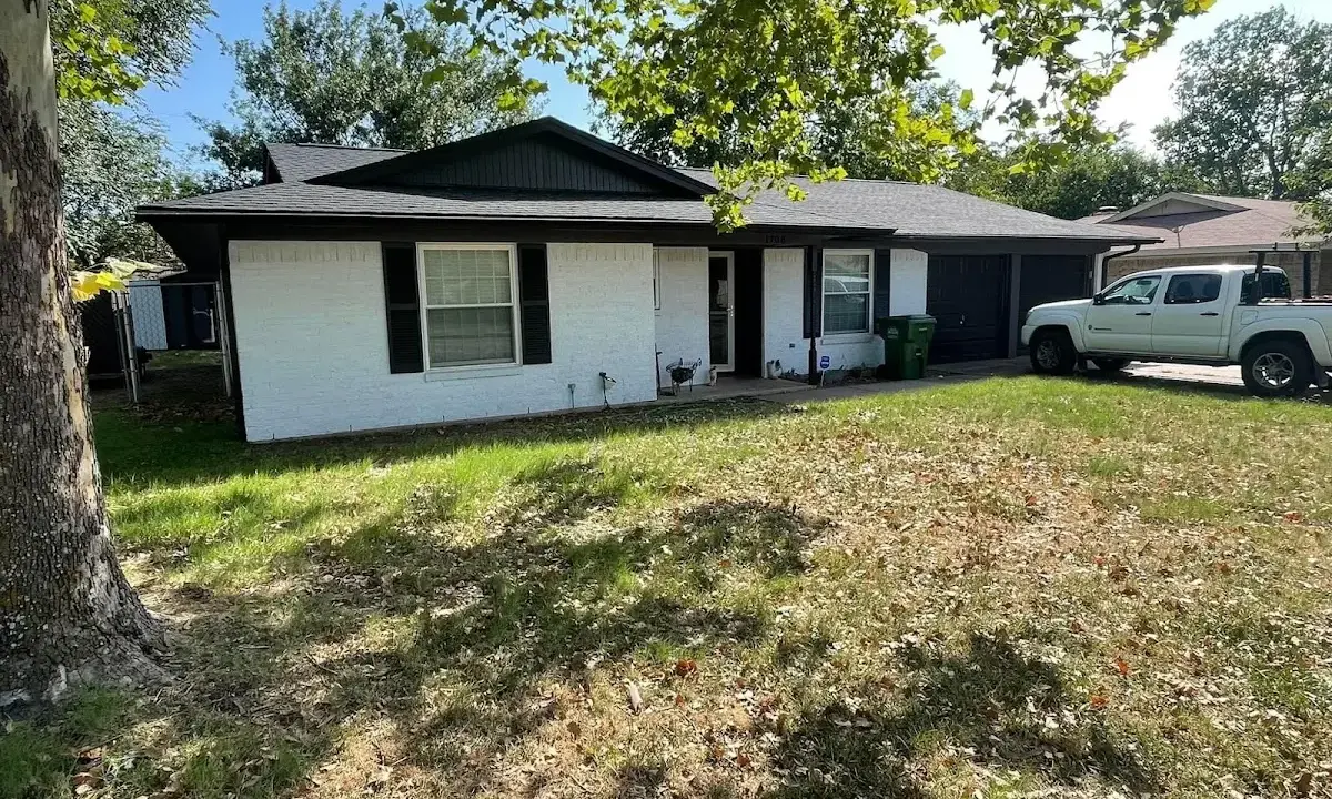 Professional roofing crew working on a residential roof in Gonzales